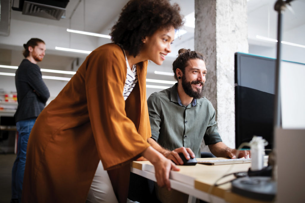 Two workers looking at computer together